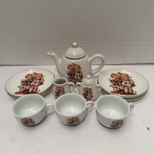 3cups, 4 dessert plates, teapot, creamer & sugar.